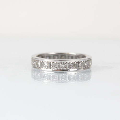 326 - A diamond full eternity ring, the twenty round cut diamonds claw set within a white metal band, ring... 