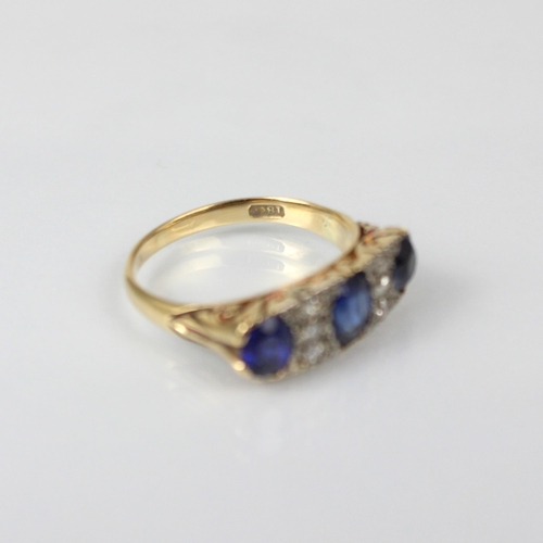 330 - A Victorian style diamond and synthetic sapphire ring, the three graduated oval cut sapphires with d... 