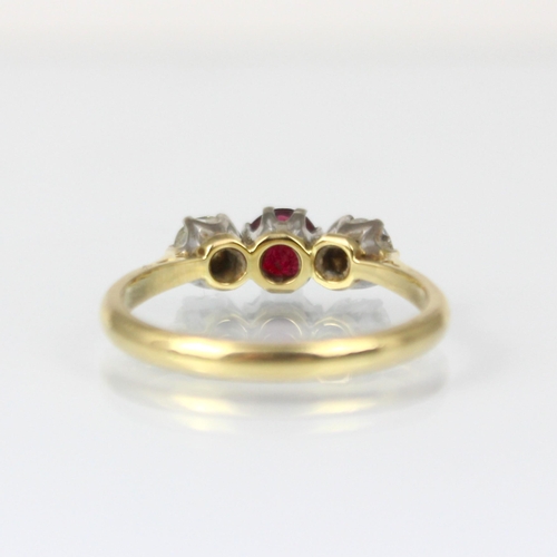 334 - An early 20th century style diamond and untested ruby three stone ring, the central round cut untest... 