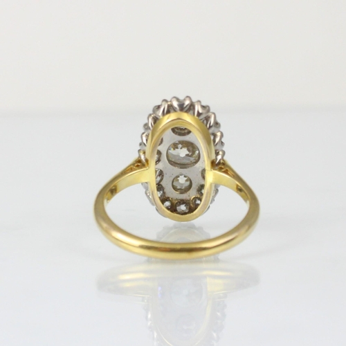 343 - An Edwardian style diamond cluster ring, the three graduated old cut diamond centre within surround ... 