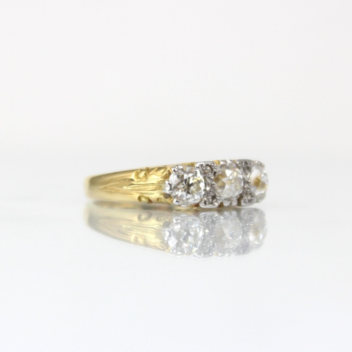 344 - A Victorian style three stone diamond ring, the central old cut diamond with smaller old cut diamond... 