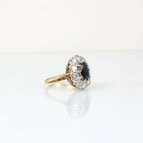 345 - An Edwardian style diamond and untested sapphire cluster ring, the central oval cut untested sapphir... 