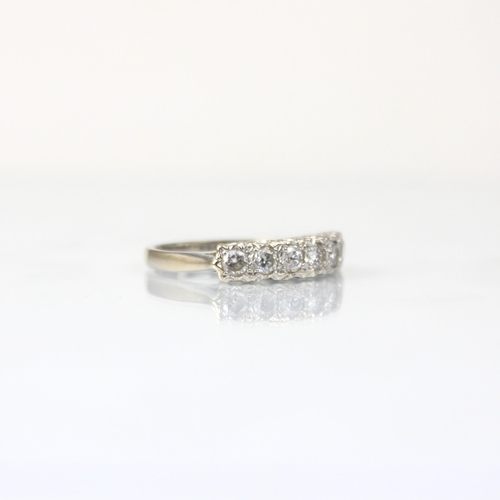 346 - An 18ct white gold diamond seven stone ring, the seven round cut diamonds within claw setting edge w... 