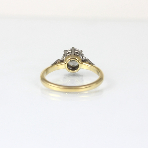 347 - An Edwardian style diamond solitaire, the central round cut diamond within stylised white metal illu... 