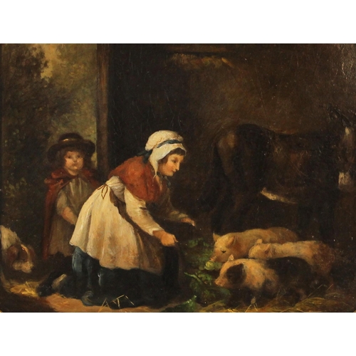 398 - English School (19th century),  
Children feeding piglets in a barn,  
Oil on oval panel,  
Unsigned... 