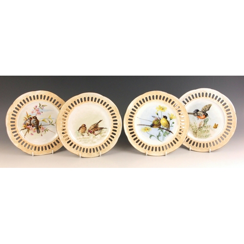 550 - Four cabinet plates, early 20th century, the wells painted over glaze with bird studies by Kate Edmu... 