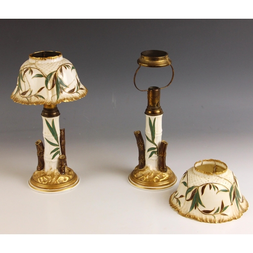 561 - A pair of Victorian Wileman Foley (pre-Shelley) 'Fola' candle lamps, late 19th century, each modelle... 