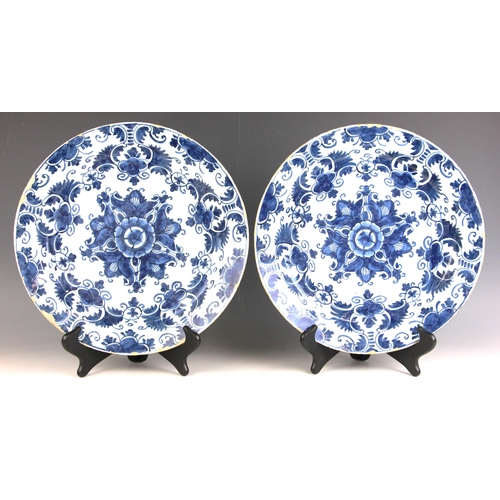 566 - A pair of Dutch Delft blue and white tin glazed earthenware chargers, late 18th or early 19th centur... 