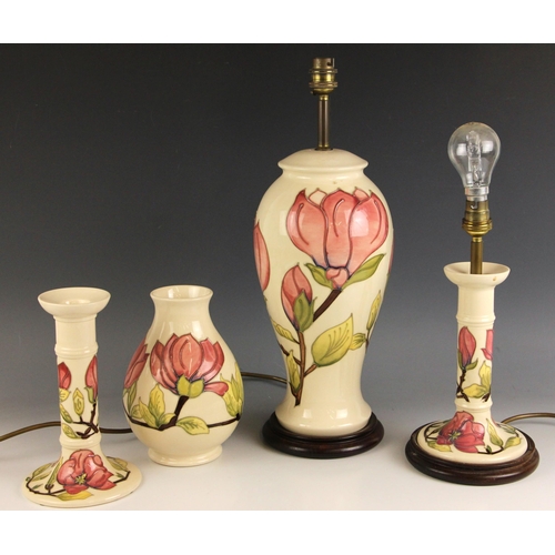 570 - A Moorcroft table lamp in the Magnolia pattern, of inverted baluster form, 35cm high excluding fitti... 