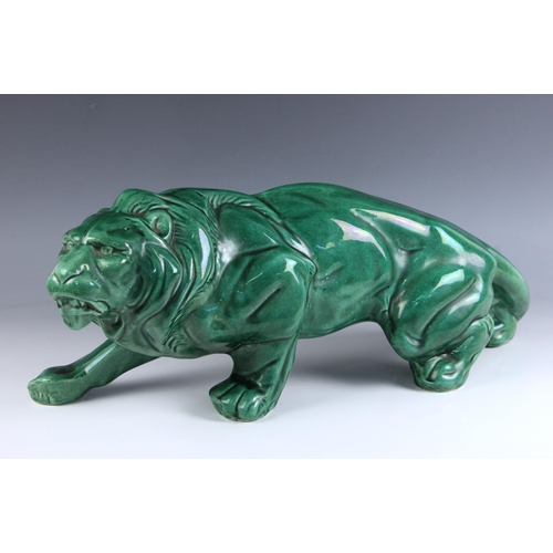 583 - An Art Deco style green glazed model of a prowling lion in the manner of Lejan, 20th century, impres... 