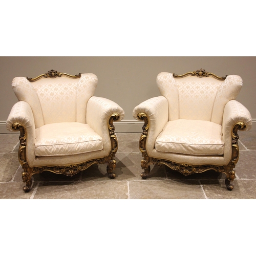 1003 - A pair of  French Louis XVI style giltwood and composite framed armchairs, mid 20th century, in ivor... 