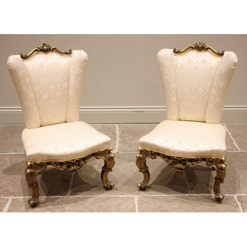 1003 - A pair of  French Louis XVI style giltwood and composite framed armchairs, mid 20th century, in ivor... 