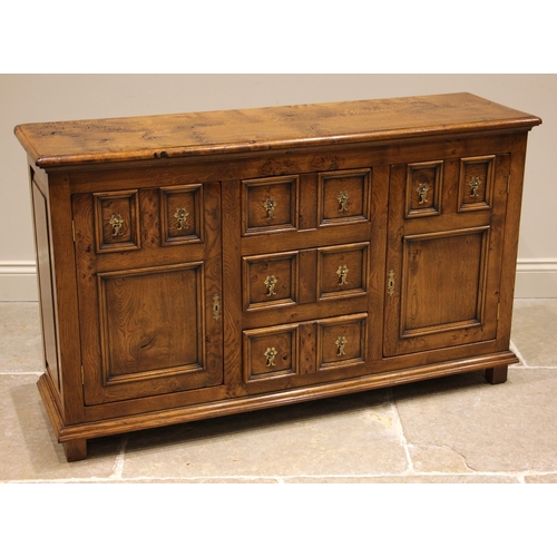 1018 - A 17th century style honey oak sideboard, late 20th century, the rectangular moulded top over three ... 