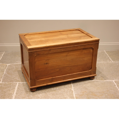 1019 - A contemporary hardwood trunk, the 'framed' and moulded cover opening to a vacant interior, with con... 