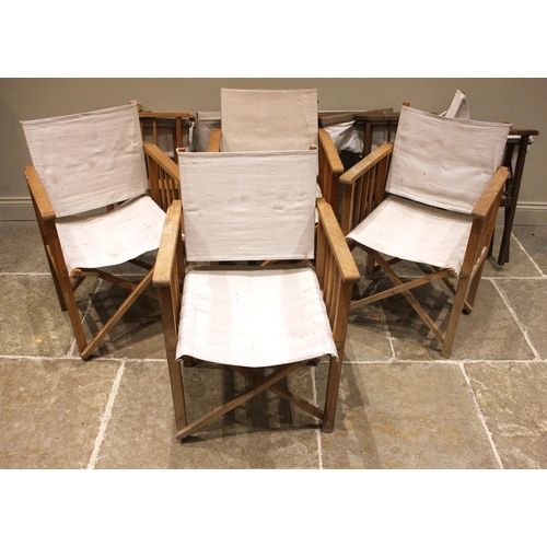 1022 - Eight oak framed directors chairs, late 20th century, each with an ivory coloured canvas seat and ba... 