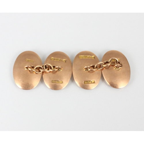 212 - A pair of early 20th century 9ct gold cufflinks, the oval cufflinks of concave form with initial to ... 