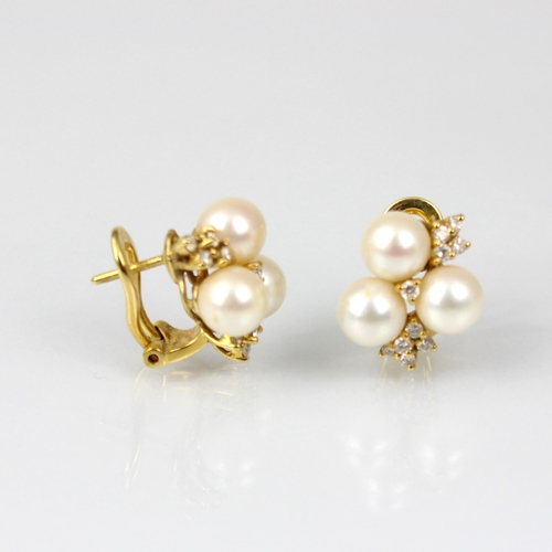 218 - A pair of 18ct yellow gold diamond and cultured pearl earrings, the three cultured pearls with ten r... 