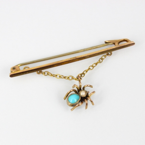 221 - An early 20th century spider brooch, the plain polished yellow metal bar brooch suspending a turquoi... 