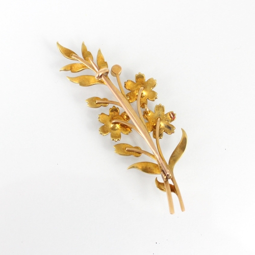 222 - A late 19th/early 20th century yellow metal seed pearl spray brooch, the floral brooch set with thre... 