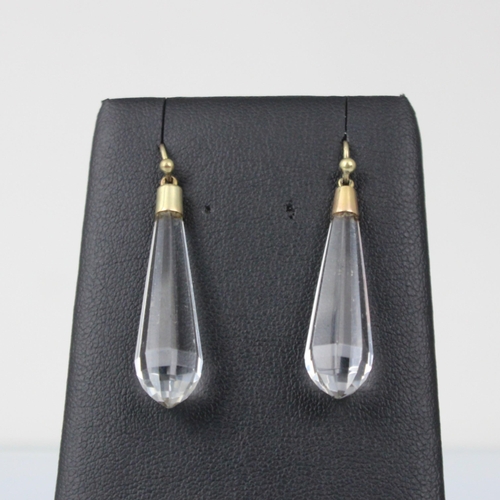 249 - A pair of Art Deco style rock crystal earrings, the faceted torpedo shaped droppers with gold colour... 