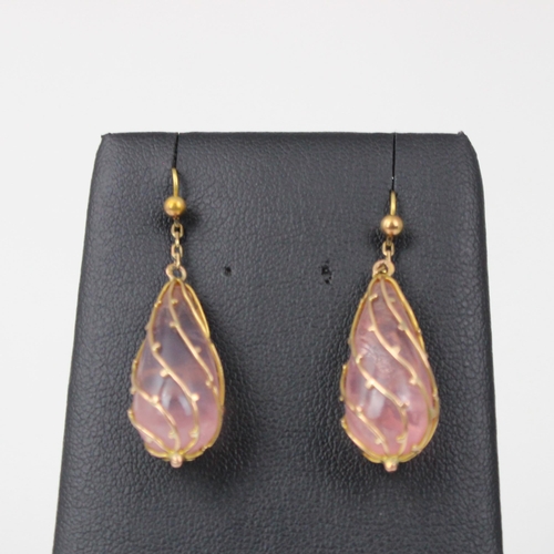 250 - A pair of Art Nouveau style rose quartz earrings, the tear drop shaped rose quartz within a yellow m... 