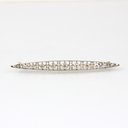 252 - An early 20th century diamond brooch, of navette form set with row of eleven graduated old cut diamo... 