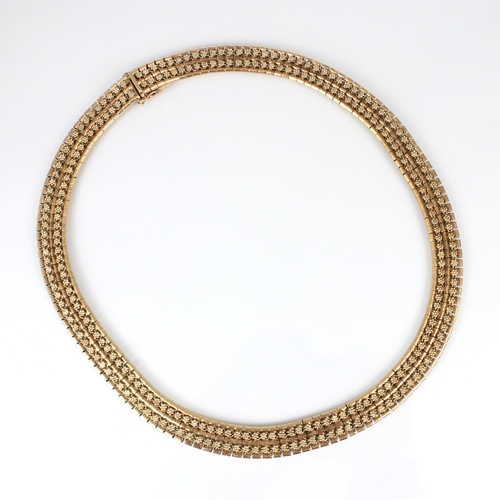 257 - A late 20th century 9ct collar style necklace, the necklace with stylised floral repeating decoratio... 