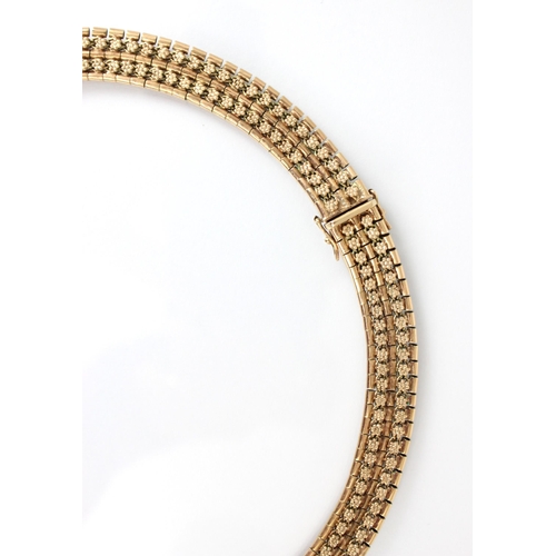 257 - A late 20th century 9ct collar style necklace, the necklace with stylised floral repeating decoratio... 