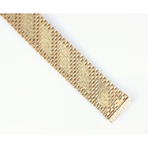 259 - A mid 20th century 9ct rose gold bracelet, the gate link bracelet with ten textured panels, stamped ... 