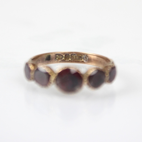 263 - A late 19th century flat cut 'garnet' ring, the five foil backed stones leading to engraved shoulder... 