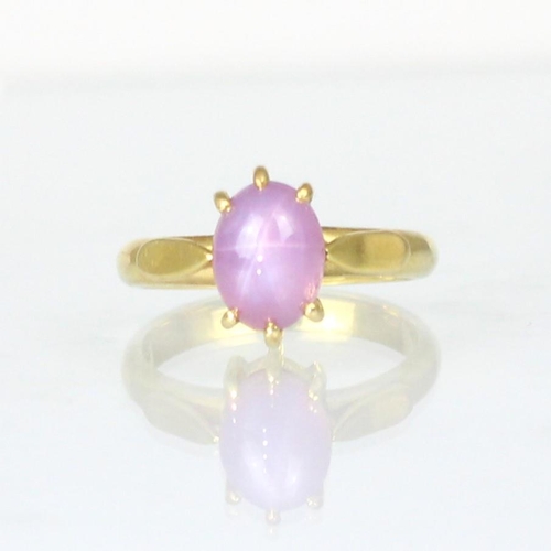 269 - A bespoke untested star ruby ring, the oval cabochon displaying six ray star, within yellow metal cl... 