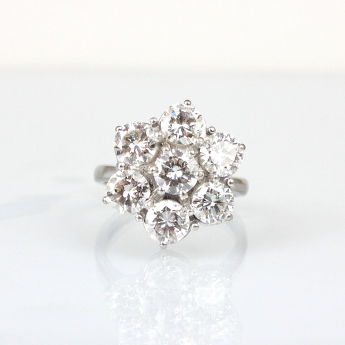 277 - A mid 20th century diamond cluster ring, the round cut diamond within floral surround of six round c... 