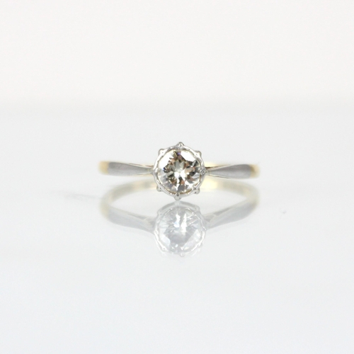 317 - A mid 20th century diamond solitaire ring, the round cut diamond within a white metal illusion setti... 