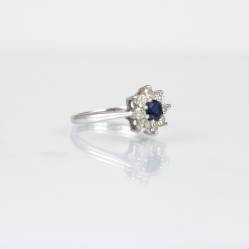 318 - A late 20th century diamond and untested sapphire cluster ring, the central round cut untested sapph... 