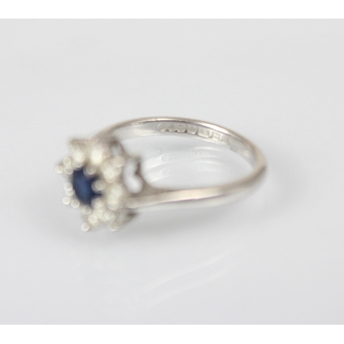 318 - A late 20th century diamond and untested sapphire cluster ring, the central round cut untested sapph... 