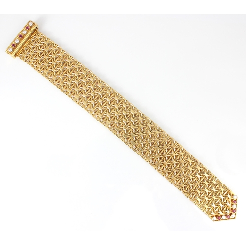 348 - A mid/late 20th century yellow metal diamond and ruby bracelet, the chain mail style links leading t... 