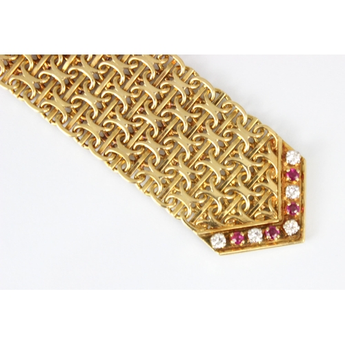 348 - A mid/late 20th century yellow metal diamond and ruby bracelet, the chain mail style links leading t... 