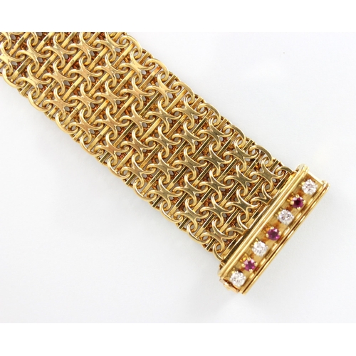 348 - A mid/late 20th century yellow metal diamond and ruby bracelet, the chain mail style links leading t... 