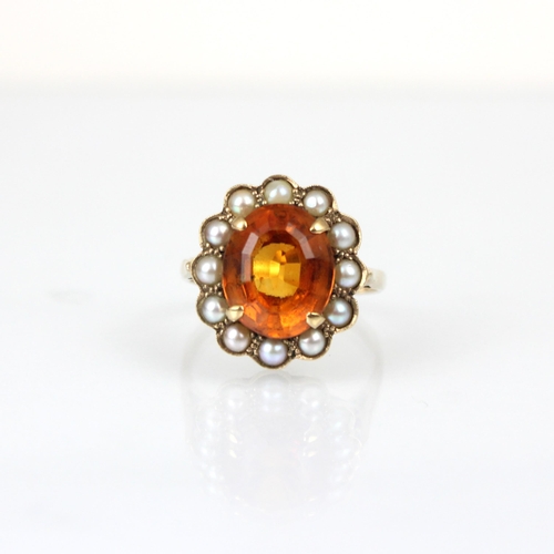 353 - An early 20th century citrine and pearl cluster ring, the central oval cut citrine within surround o... 