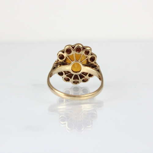 353 - An early 20th century citrine and pearl cluster ring, the central oval cut citrine within surround o... 