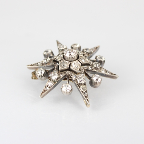 355 - A 19th century diamond brooch/pendant, the central old cut diamond within stylised flowerhead, encom... 