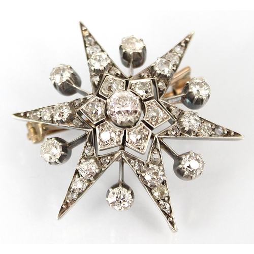 355 - A 19th century diamond brooch/pendant, the central old cut diamond within stylised flowerhead, encom... 