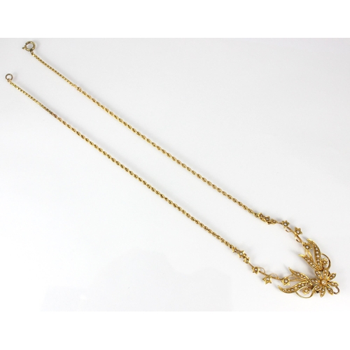 357 - A late 19th/early 20th century yellow metal seed pearl necklace, the central floral motif within sty... 