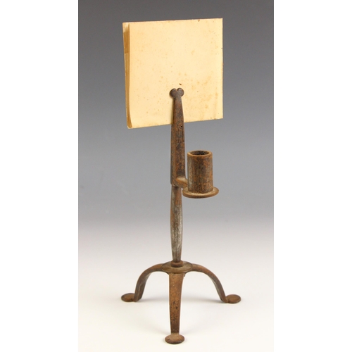 505 - An 18th century wrought iron rush nip or light, supported by three legs with pad feet, with single c... 