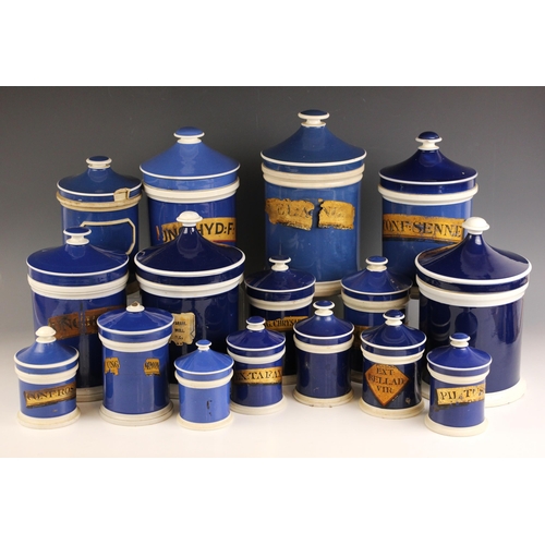 734 - Sixteen blue glazed earthenware apothecary jars, 19th century, each of cylindrical form with conical... 