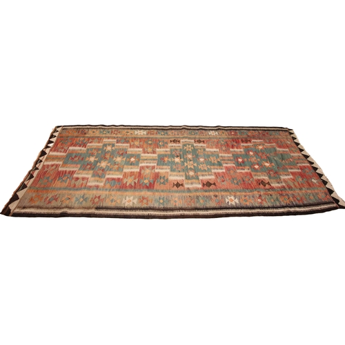 801 - A flat weave kilim rug, in red, green and brown colourways, the central red field with three linked ... 