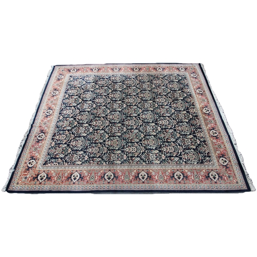 802 - A Chinese heavy pile wool carpet, the navy blue central field with an all over foliate design, enclo... 