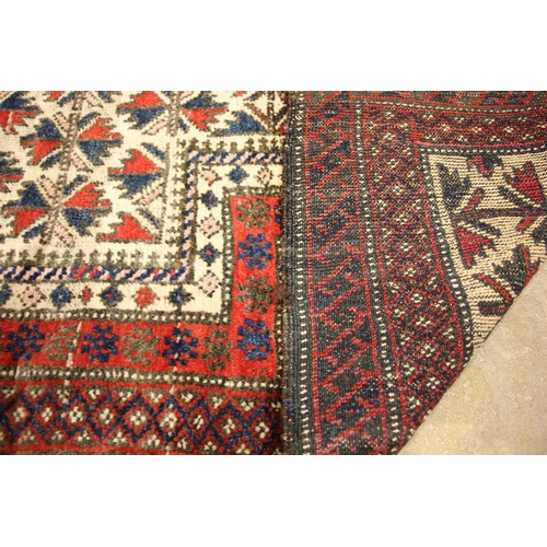 804 - An Afghan Baluchi wool pile prayer rug, in red, blue and ivory colourways, the central field overlai... 