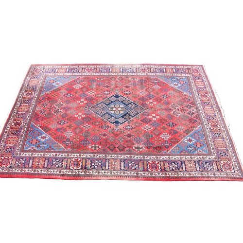 812 - A fine hand woven washed red ground Persian Joshagan carpet, in red, blue and ivory colourways, the ... 