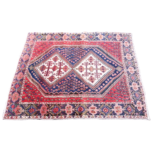 815 - A vintage hand woven Persian Afshar rug, the twin central lozenge medallions upon a blue field withi... 